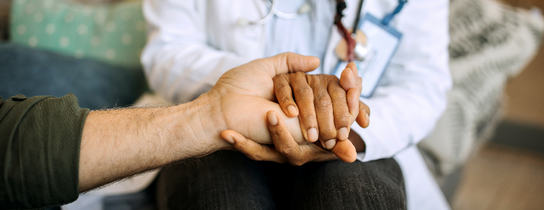 doctor and patient holding hands